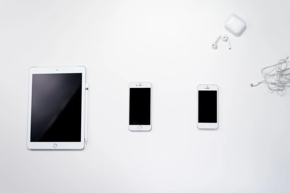 A contemporary workspace showcasing a laptop, tablet, and smartphones, ideal for tech and freelance use.